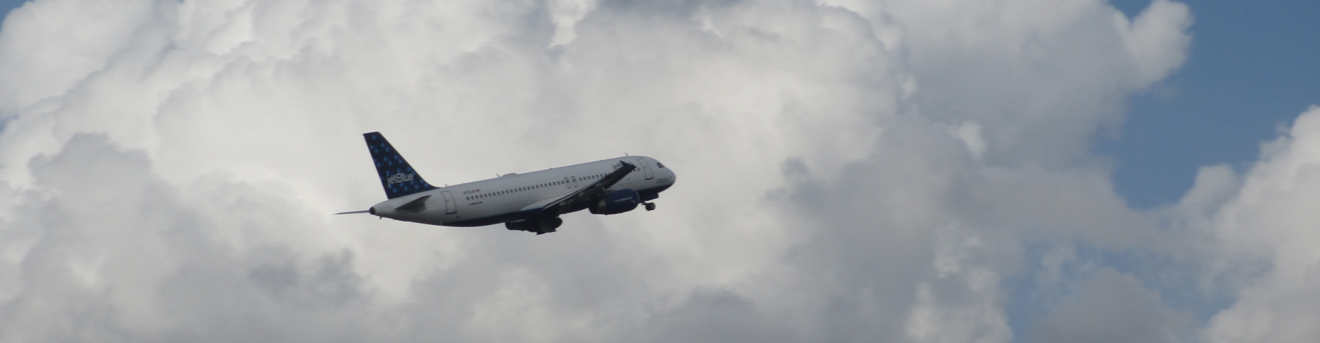 Picture of a Plane Flying into the Clouds